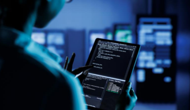 IT specialist programming and maintaining servers in a modern data centre.
